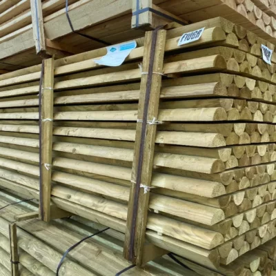 Half Round treated timber rails stacked and on a pallet