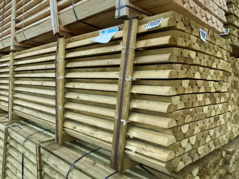 Half Round treated timber rails stacked and on a pallet